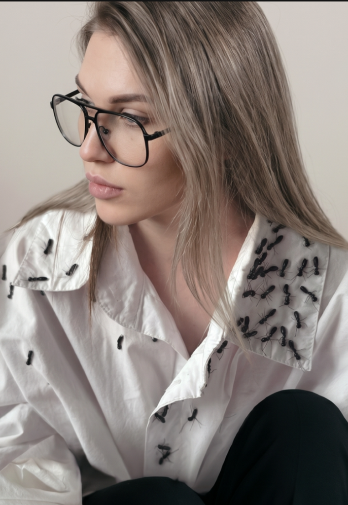 Tanya, founder of OMaGe Lab, wearing Myrmecophobia Shirt with handmade black ant bead embroidery, avant-garde streetwear design.